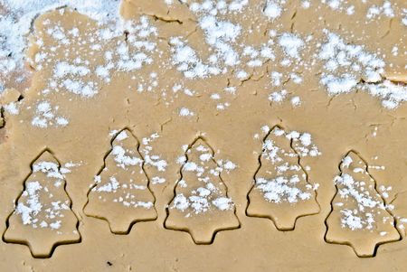 gouged tree shapes in the dough with flourの写真素材