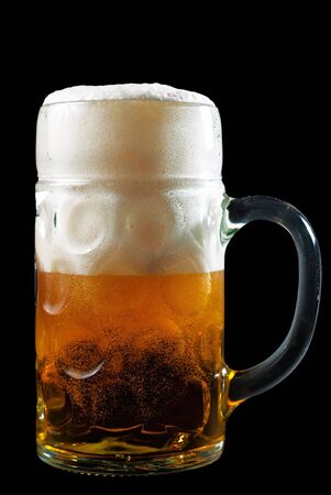 a beer mug filled with beer and foamの写真素材