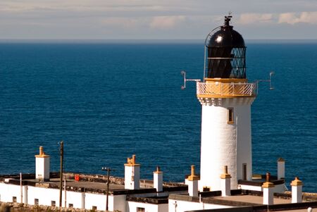 lighthouse at the sea against a blue skyの写真素材