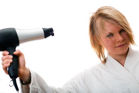 young blond woman with a hair dryer on a white backgroundの写真素材