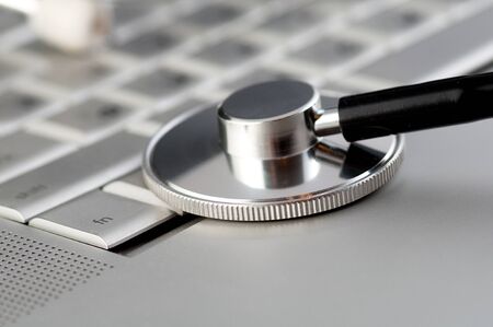 Stethoscope on a laptop keyboardの写真素材