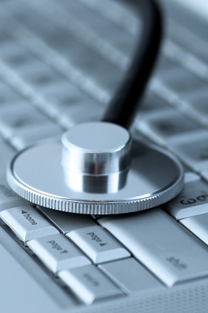 Stethoscope on a laptop keyboardの写真素材