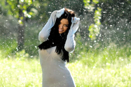 Cheerful young women on green with poplar downの写真素材