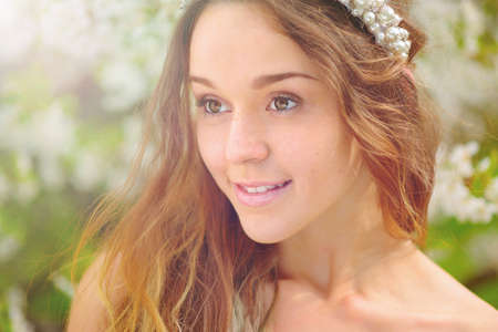 Cheerful young women with flowersの写真素材