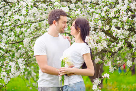 happy young couple in the gardenの写真素材