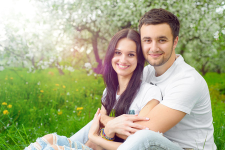happy young couple in the gardenの写真素材