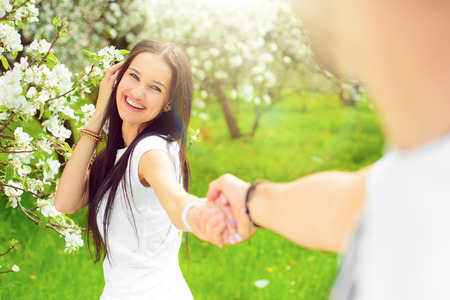 happy young couple in the gardenの写真素材
