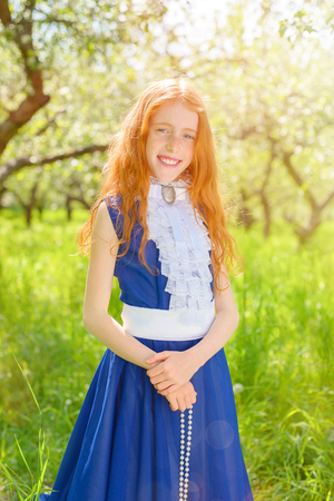 redhair girl in a sunny gardenの写真素材