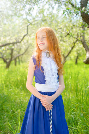 redhair girl in a sunny gardenの写真素材