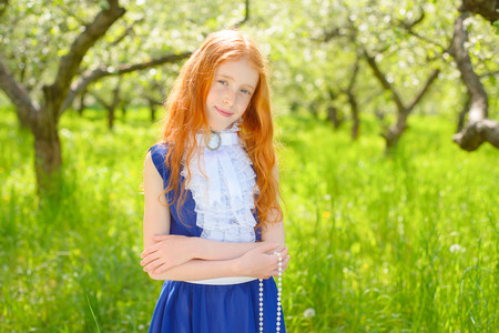 redhair girl in a sunny gardenの写真素材