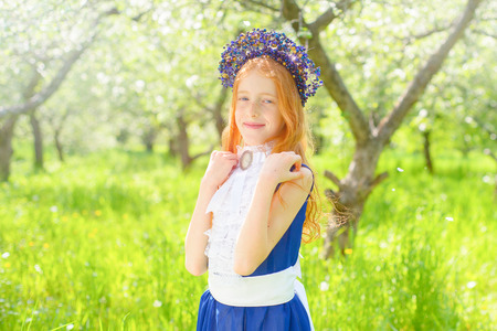 redhair girl in a sunny gardenの写真素材