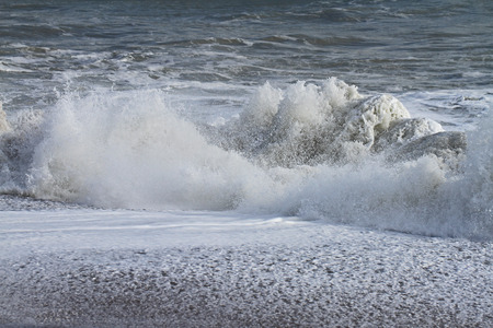 Rough or angry sea in winter in Porto Recanati in the province of Ancona Italy near Monte Conero with the sea foaming or boiling and splashing on the beachの写真素材