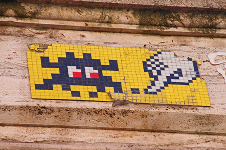brightly coloured panel on a street in Rome with a mosaic design