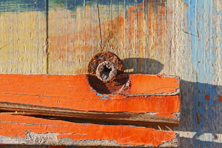 rusty screw and peeling paint on a beach cabin with distressed wood grain in winter in Italy on the Adriatic coastの写真素材