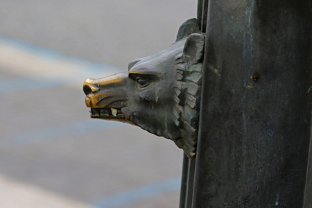 Detail on a public lamppost or street lamp in the streets of Rome, showing the Roman symbol of the wolf or Romulus and Remusの写真素材