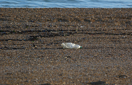 plastic bottle trash rubbish or waste on a beach on the shore of the Adriatic Sea in Numana and Porto Recanati Italy in winterの写真素材