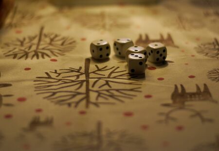 DICE ON A TABLE WITH A SOFT LIGHT