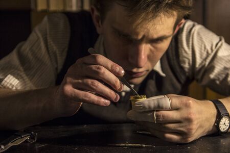 The watchmaker is repairing the mechanical watches in his workshop