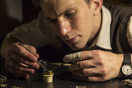 The watchmaker is repairing the mechanical watches in his workshopの写真素材