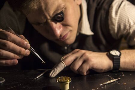 The watchmaker is repairing the mechanical watches in his workshop