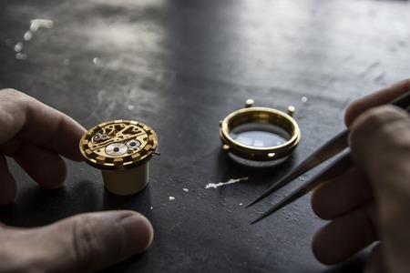 Watch maker is repairing a vintage automatic watch.の写真素材