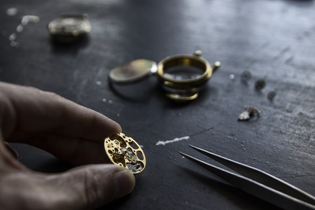 Watch maker is repairing a vintage automatic watch.の写真素材