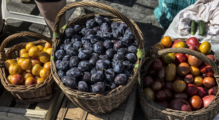 Domestic fruits and vegetables in wooden baskets, marketの写真素材
