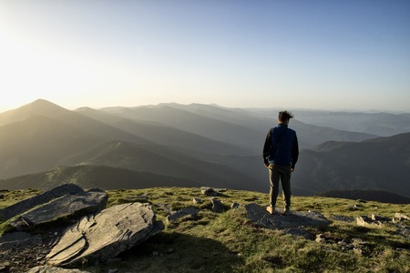 Man is feeling freedom in the top of the mountianの写真素材