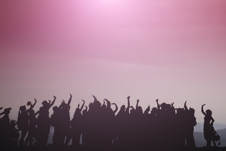 Funny people with their hands up, fun, sunsetの写真素材