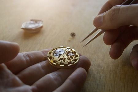 Watch maker is repairing a vintage automatic watch.の写真素材
