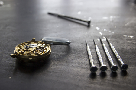 Watchmaker is repairing the mechanical watches in his workshop