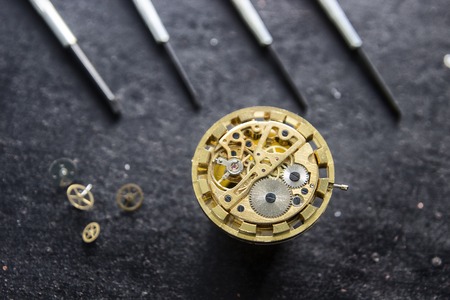 Watchmaker is repairing the mechanical watches in his workshopの写真素材