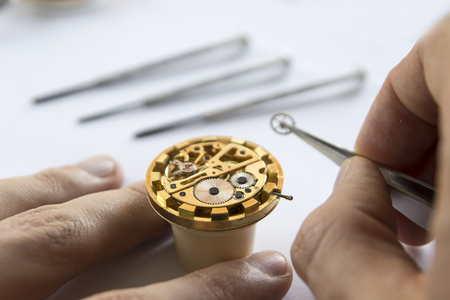 Watch maker is repairing a vintage automatic watch.の写真素材