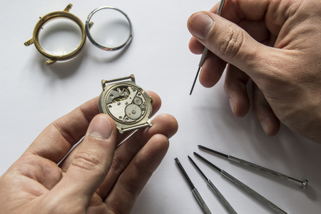 Watchmaker is repairing the mechanical watches in his workshopの写真素材