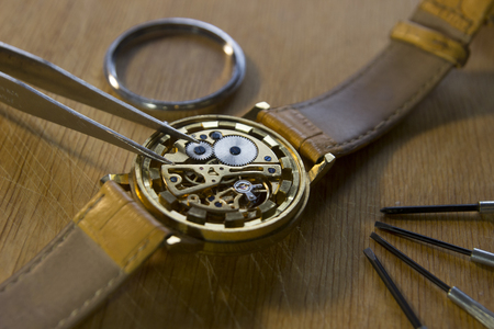 Watchmaker is repairing the mechanical watches in his workshopの写真素材