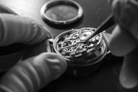 Watchmaker is repairing the mechanical watches in his workshopの写真素材