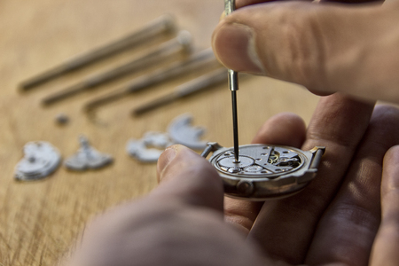 Watchmaker is repairing a vintage automatic watch.の写真素材