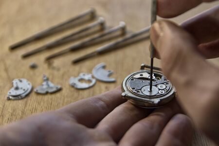 Watchmaker is repairing a vintage automatic watch.の写真素材