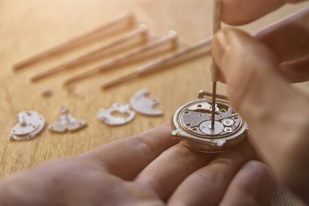 Watchmaker is repairing a vintage automatic watch.の写真素材