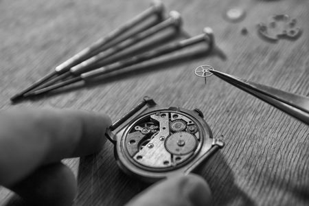 Watchmaker is repairing a vintage automatic watch.の写真素材