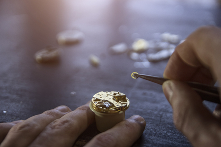 Watchmaker is repairing the mechanical watches in his workshopの写真素材