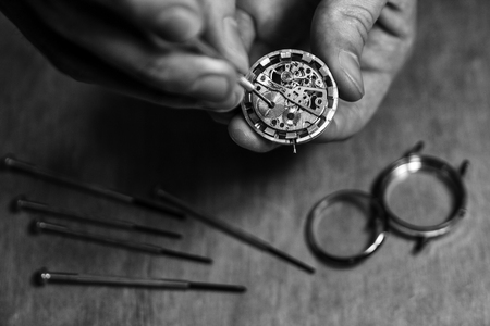 Watchmaker is repairing the mechanical watches in his workshop