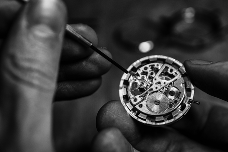Watchmaker is repairing the mechanical watches in his workshopの写真素材