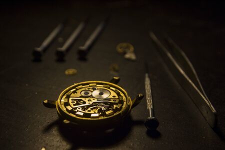 Watchmaker is repairing the mechanical watches in his workshopの写真素材