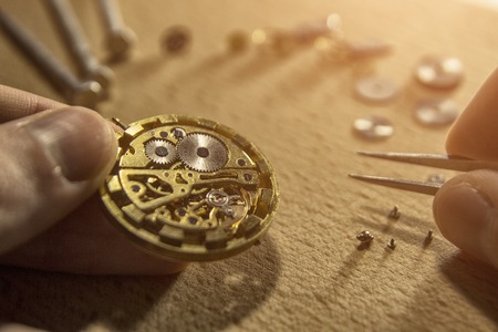 Watchmaker is repairing the mechanical watches in his workshop