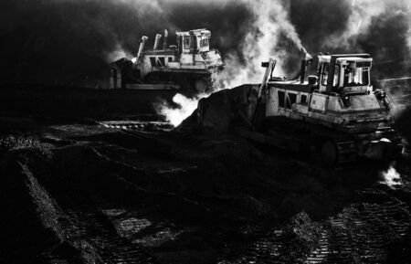 Two excavators are working, dirty job, mudの写真素材