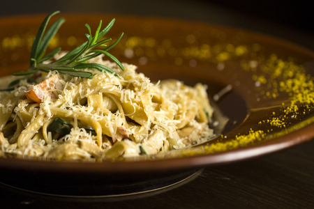 Delicious pasta wih branch of rosemary and cheeseの写真素材