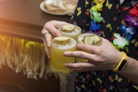 Man is holding three cocktails, tropical cocktailsの写真素材