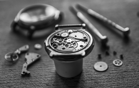 Watchmaker is repairing the mechanical watches in his workshopの写真素材