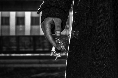 Man is smoking a cigarette, man's hand, close upの写真素材